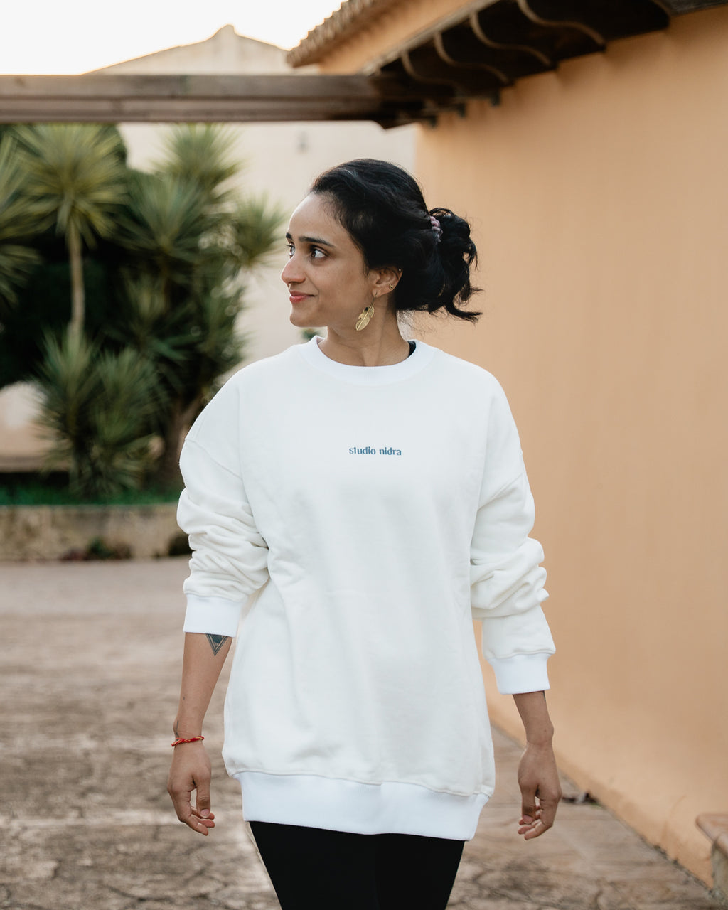 Woman wearing the Crew Sweatshirt Marshmallow White - front view showing organic cotton with peach finish